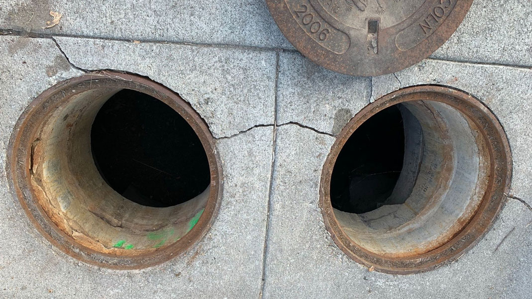 The manholes leading to the hydrodynamic separator located underground