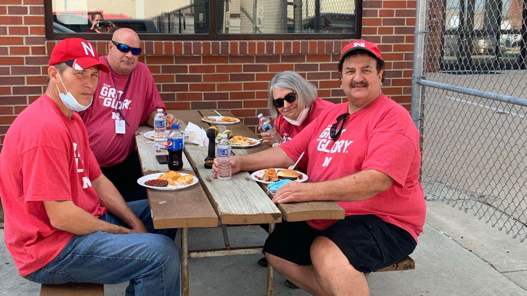 StarTran bus operators at a picnic table during a football game tailgate event