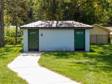 oberts Park has a permanent restroom off of the paved walking path.