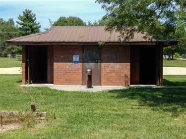 UPCO park's restroom is a brick building connected to the paved walking path.