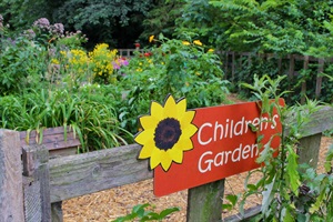 A red sign with a yellow sunflower in the corner reads 