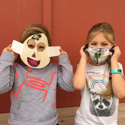 Two campers show off their masks.