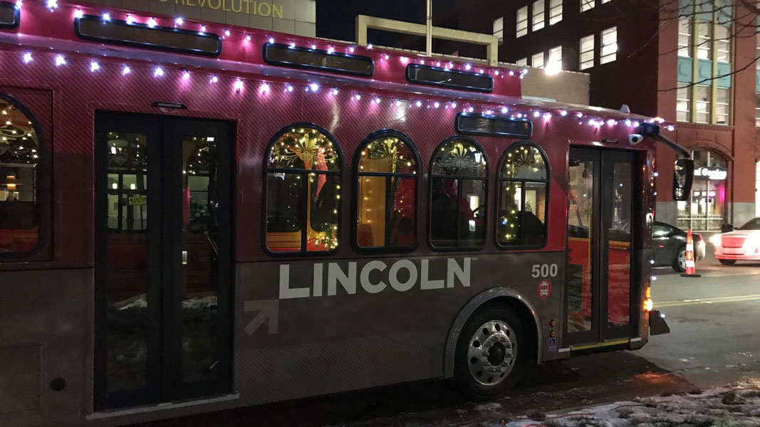 StarTran trolley-style bus decorated with holiday lights