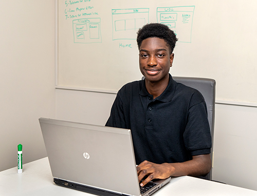 Israel, a participant in the Mayor's Youth Employment Program, poses for a photograph.