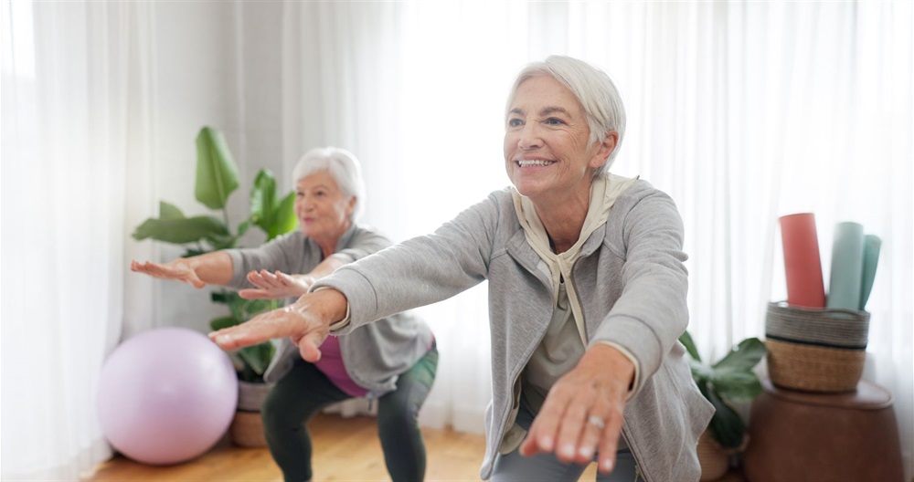 two women doing indoor yoga