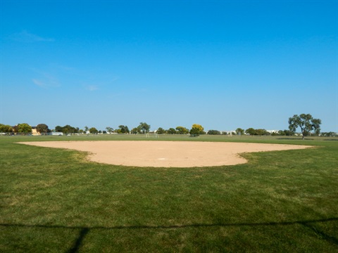 Arkfeld ballfield looking from the green, irrigated outfield into the infield.