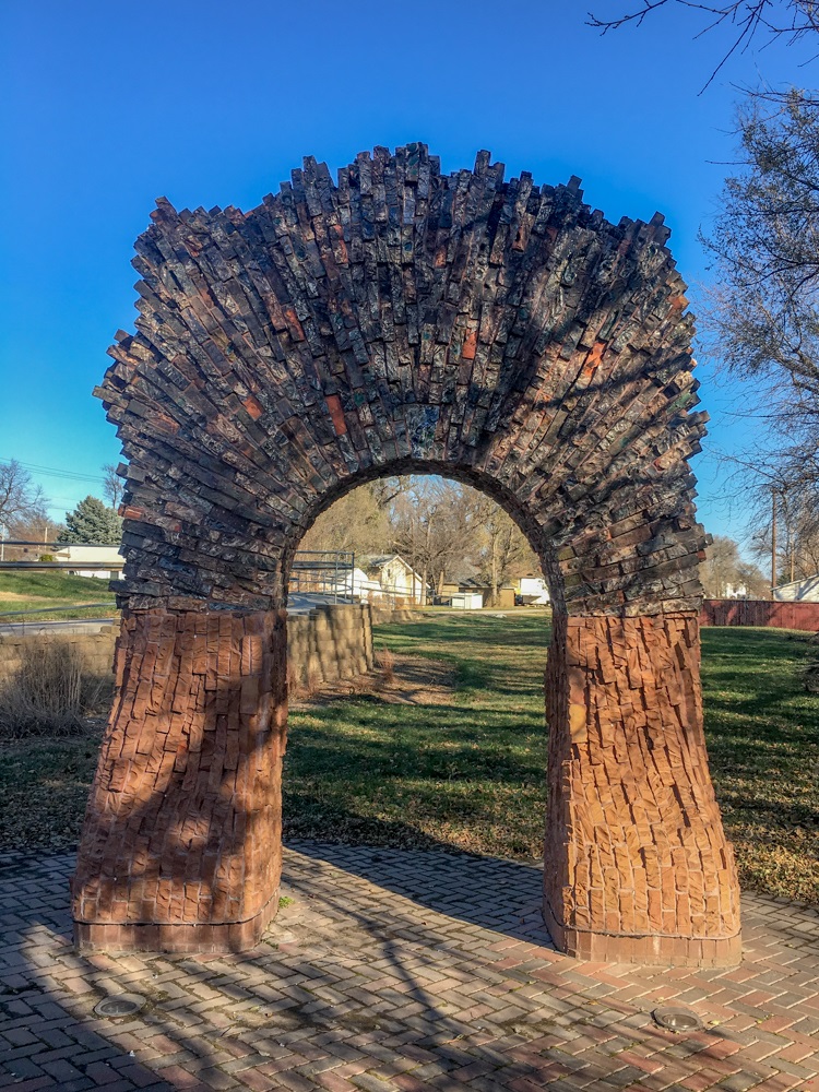 An archway made of varied sized and colored bricks