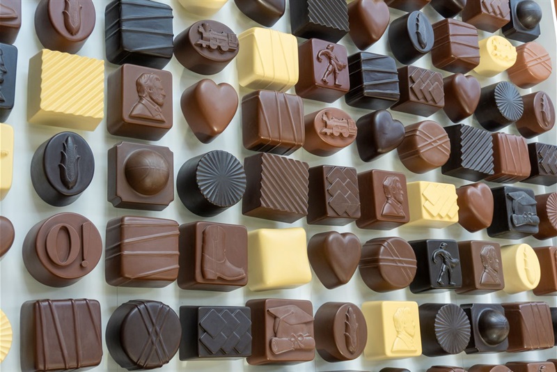 The sculpture of a box of chocolates with designs for symbols of Lincoln on it. There is a variety of colors of chocolate and a variety of designs