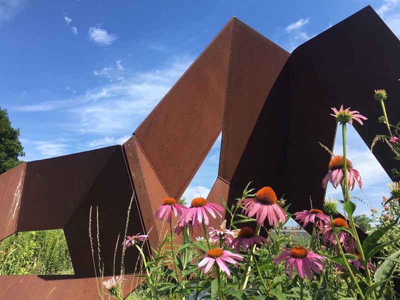 a closeup of the geometric forms and the flowers in front of it