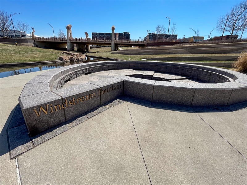 The conch shaped fountain is made of stones, with the words Windstream Fountain in raised letters on the outside.