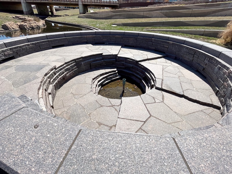 The interior of the Windstream fountain without the water going, revealing the layers of rocks forming the conch shell formation.