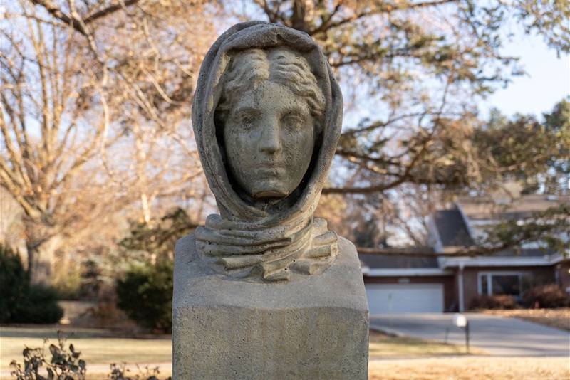 one of the four heads at Kontras Park, a stone head of a young woman