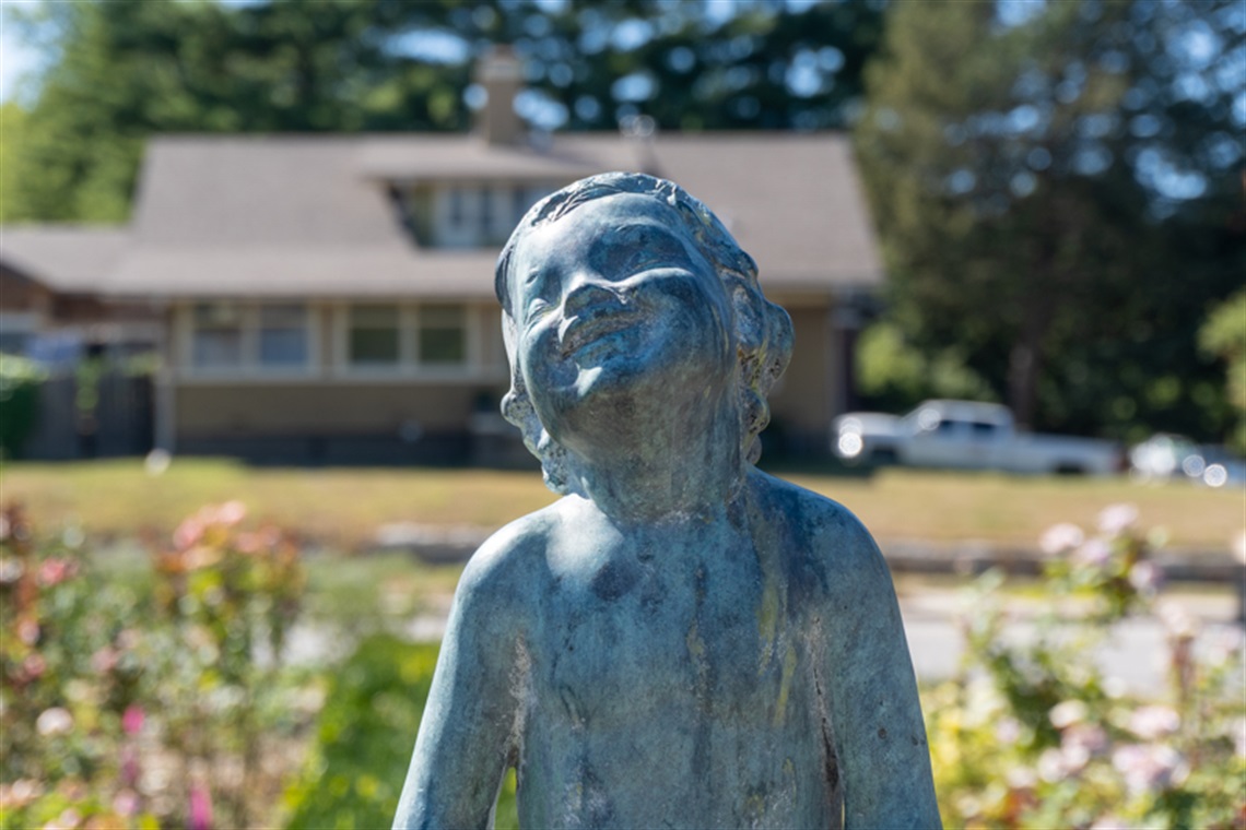 close up shot of a sculpture of a young child smiling