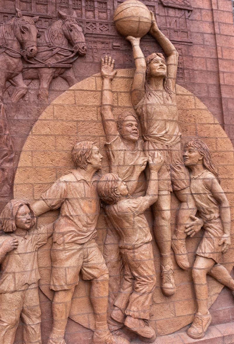 A close up of the children playing basketball as part of the brick mural on F Street Community Center
