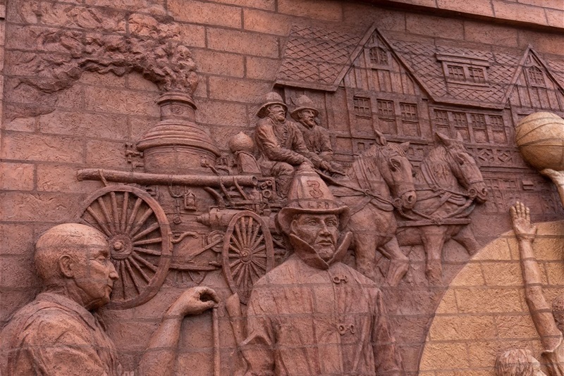A close up of the firefighters on a brick mural