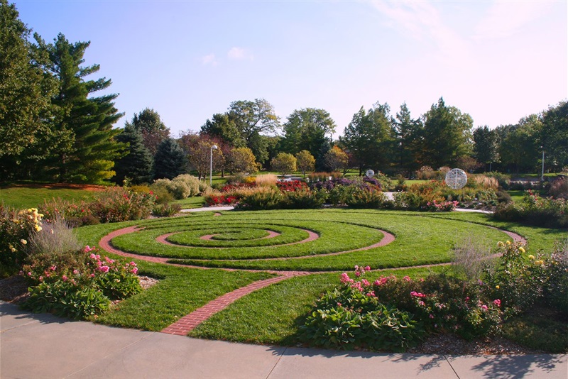 The Hamann Rose Gardens feature a rose spiral path of bricks, and Sphere 1 & 2 rise in the background.