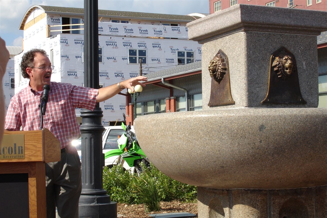At the dedication of the fountain, Director Lynn Johnson gestures towards the fountain
