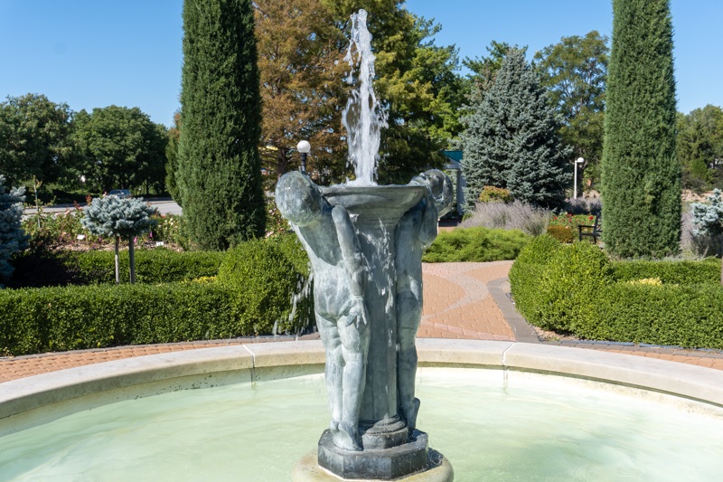 Joy fountain shows two children displaying pure joy while playing in the water while holding the fountain up.
