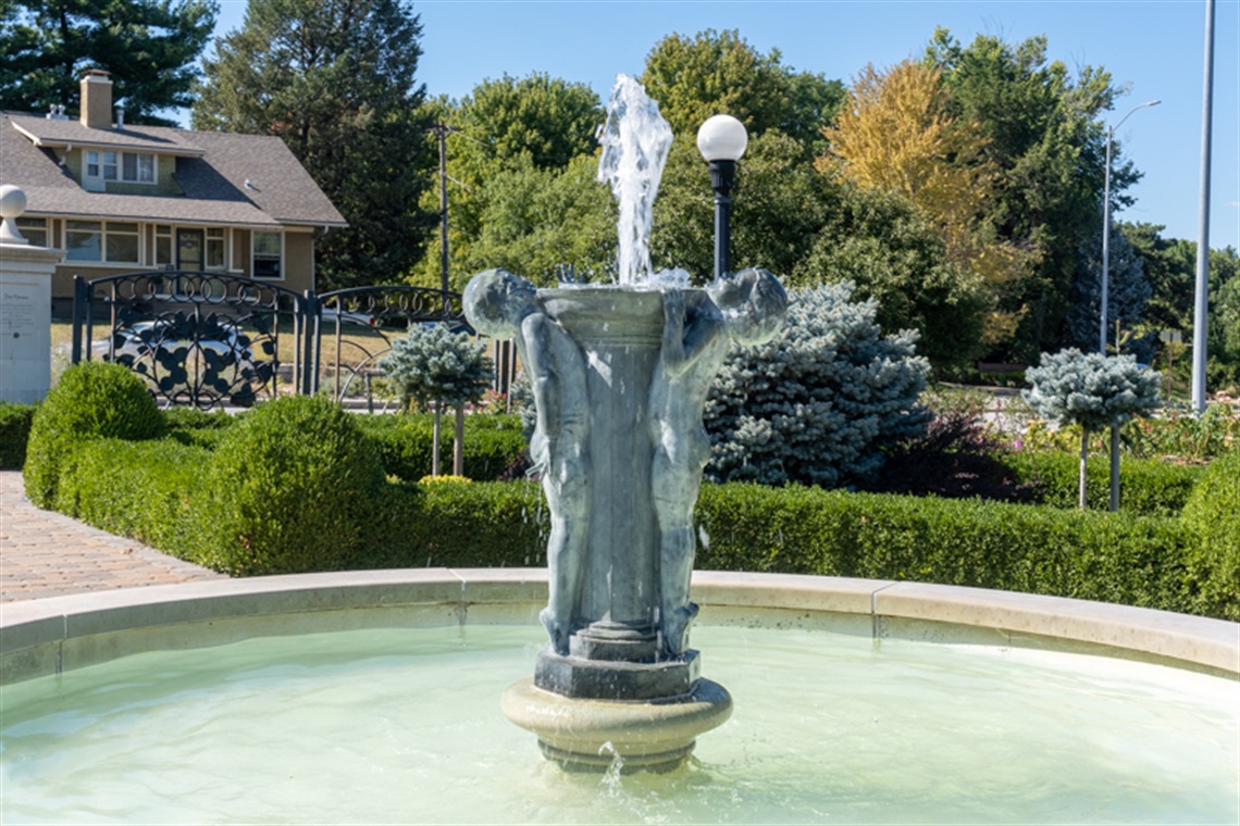 Joy fountain shows two children displaying pure joy while playing in the water while holding the fountain up.