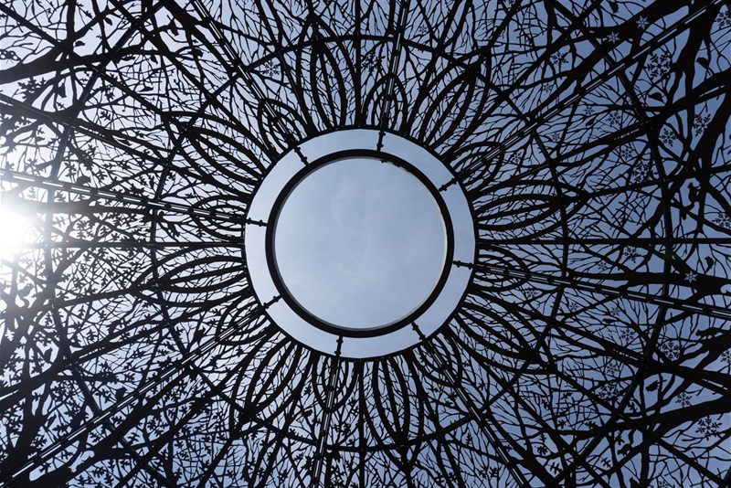 Looking up into the top of the Rotary Gazebo shows a flower pattern with an opening to the sky as the center. 