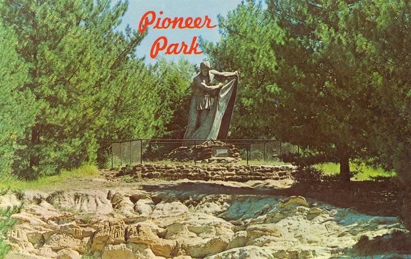 An old postcard for Pioneers Park, featuring the Smoke Signal Sculpture on the hilltop