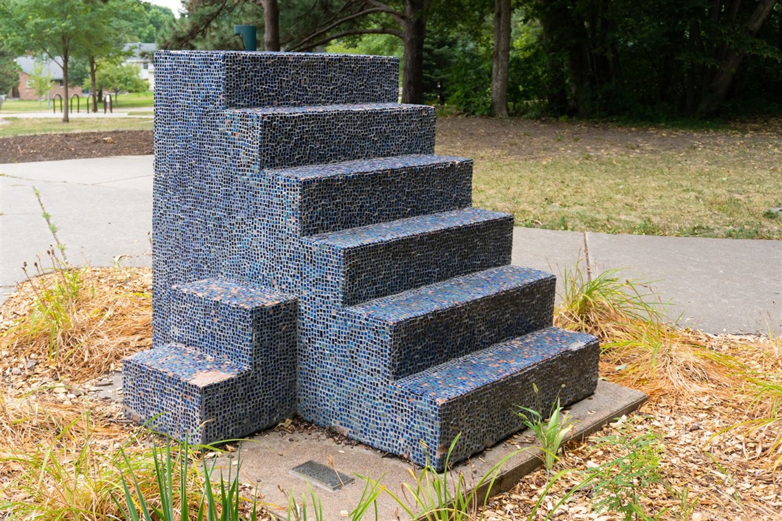 Blue tiled Stairs artwork located in a park.