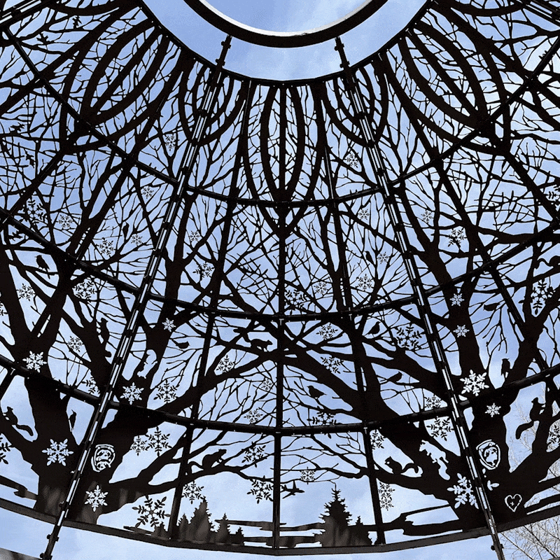 Rotating around the inside of the rotary gazebo showcasing a canopy of trees with various animals and Lincoln landmarks interspersed. 