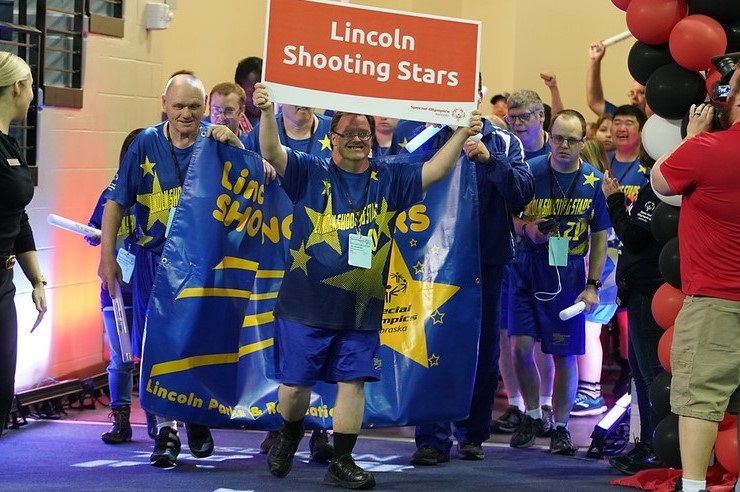 Lincoln Shooting Stars Special Olympics team entering summer games opening ceremonies.