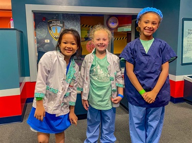 Field trips! Three campers enjoy imaginative play while visiting the Lincoln Children's Museum.
