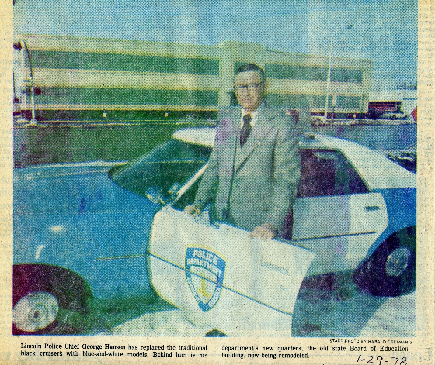 Chief George Hansen standing in front of a Police cruiser