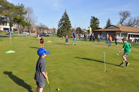 Youth playing putt putt golf at Ager Golf Course