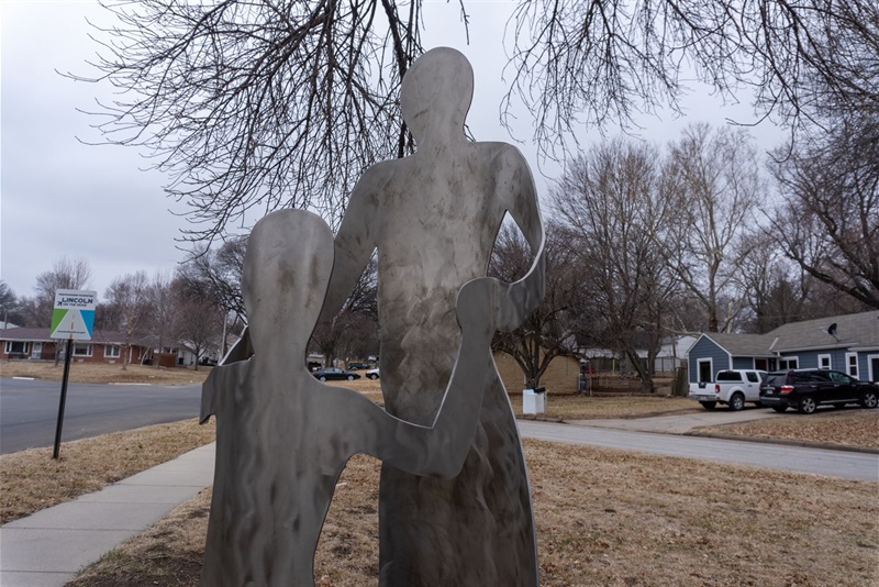 Two metal forms, one of a parent and one of a child connected at the hands