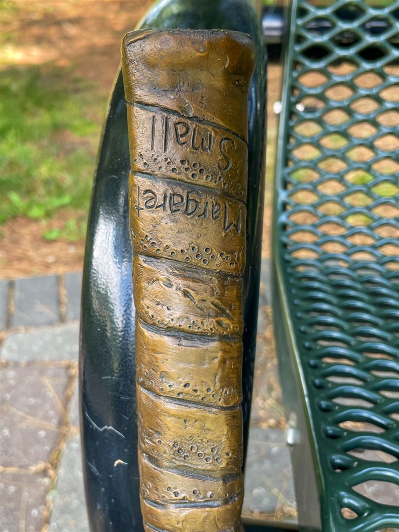 The handle of the bronze tennis racket featuring the artists name