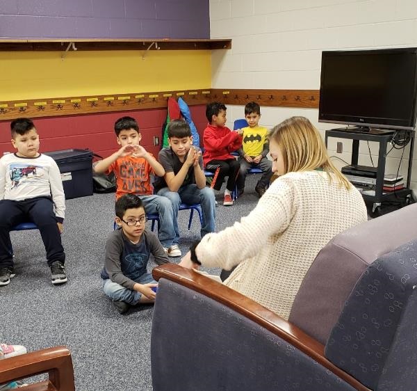 Belmont students sit down for a project demonstration by After School staff. 