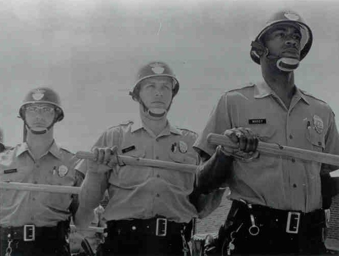 Officer Maxey holding a baton